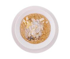 Almond and coconut porridge in white bowl photo