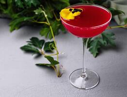 Elegant cocktail with edible flower garnish photo