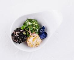 Gourmet cheese balls with herbs on elegant white dish photo