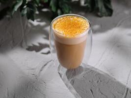 Golden milk latte in a modern glass photo