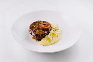 Gourmet steak with mashed potatoes on elegant plate photo