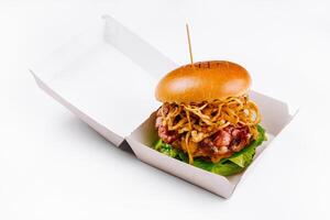 Gourmet burger with crispy onions in takeout box photo