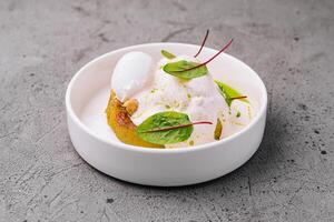 Gourmet dessert with lemon foam and greens photo