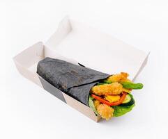 Charcoal wrap with crispy chicken on white background photo