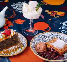 Assorted desserts on colorful tablecloth photo