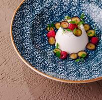 Elegant vanilla panna cotta with fresh berries photo