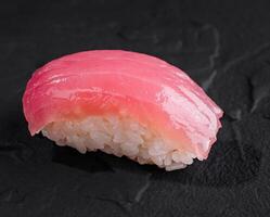 Succulent tuna nigiri sushi on dark slate photo