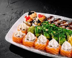 Assorted sushi platter on dark background photo