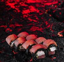 Sushi selection on molten lava texture photo