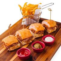 Tasty slider burgers with fries and dipping sauces photo