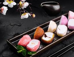 Assorted mochi ice cream on dark slate background photo