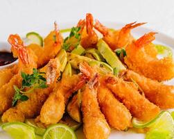 Crispy fried shrimp with lime and sauce photo