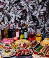 Festive holiday feast with decorated christmas tree photo