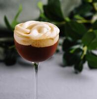 Elegant espresso martini with frothy top photo