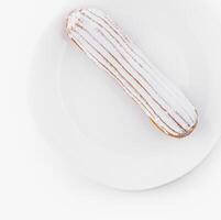 Fresh eclair on white plate photo