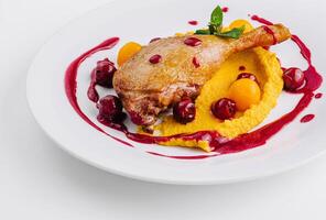 Gourmet duck confit with berry sauce photo