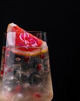 Elegant cocktail with citrus garnish on dark background photo