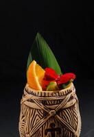 Exotic tiki cocktail mug with tropical garnish photo