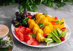 fruit platter and glass jar of green tea photo