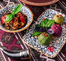 Traditional ethnic cuisine on ornate tablecloth photo