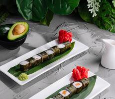 Delicious sushi platter on modern ceramic plates photo