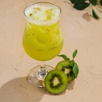 Fresh kiwi cocktail on a sunny table photo