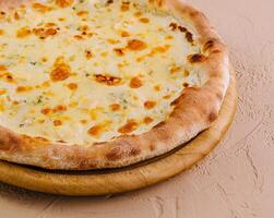 Fresh baked cheese pizza on wooden board photo