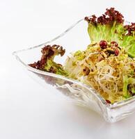 coleslaw with pistachios in a glass bowl photo