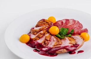 Gourmet duck breast with berry sauce and apricots photo