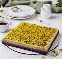 Pistachio cake on elegant table setting with coffee photo