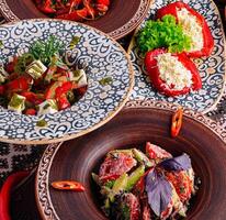 Colorful mediterranean feast on ethnic tableware photo