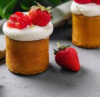 Fresh strawberry tarts on grey backdrop photo