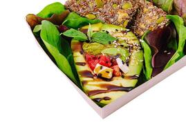 Healthy vegan lunch box with avocado and grains photo