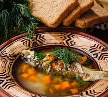 Traditional fish soup in rustic setting photo