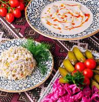 Traditional slavic cuisine assortment on ornate tablecloth photo