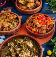 Traditional african stews served in clay pots photo