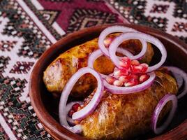 Traditional georgian dish shkmeruli in ceramic bowl photo