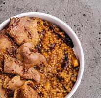 Hearty lentil stew with sliced meat photo