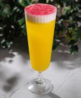 Refreshing tropical mimosa cocktail with frothy top photo