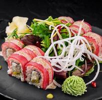 Gourmet sushi roll platter on black slate photo