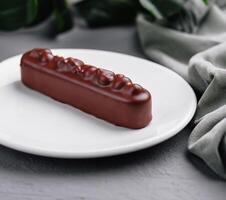 Elegant chocolate bar dessert on white plate photo