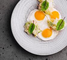 Gourmet breakfast plate with poached eggs and greens photo