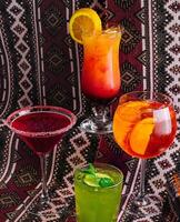 Assorted cocktails on a patterned backdrop photo