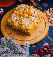 Festive homemade napoleon cake on wooden board photo