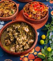 Traditional african stews served in clay pots photo