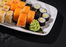 Assorted sushi platter on dark background photo