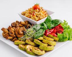 Fresh vegan meal assortment on white photo