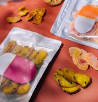 Assorted dehydrated fruits and meats in vacuum sealed packaging photo