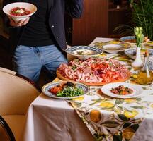 Man enjoying a feast of italian dishes photo