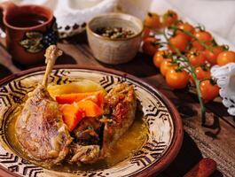 Traditional roasted duck leg with vegetables photo